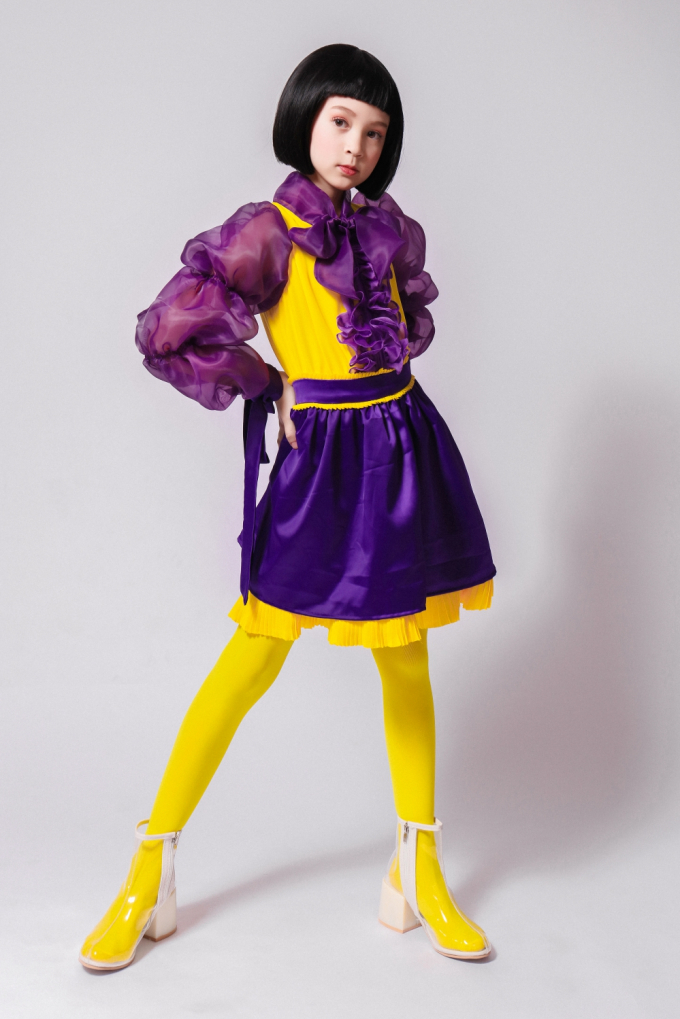 Ấn tượng thị giác về trang phục càng tăng lên khi các bé gái diện thêm tất cao cổ đồng màu với trang phục.